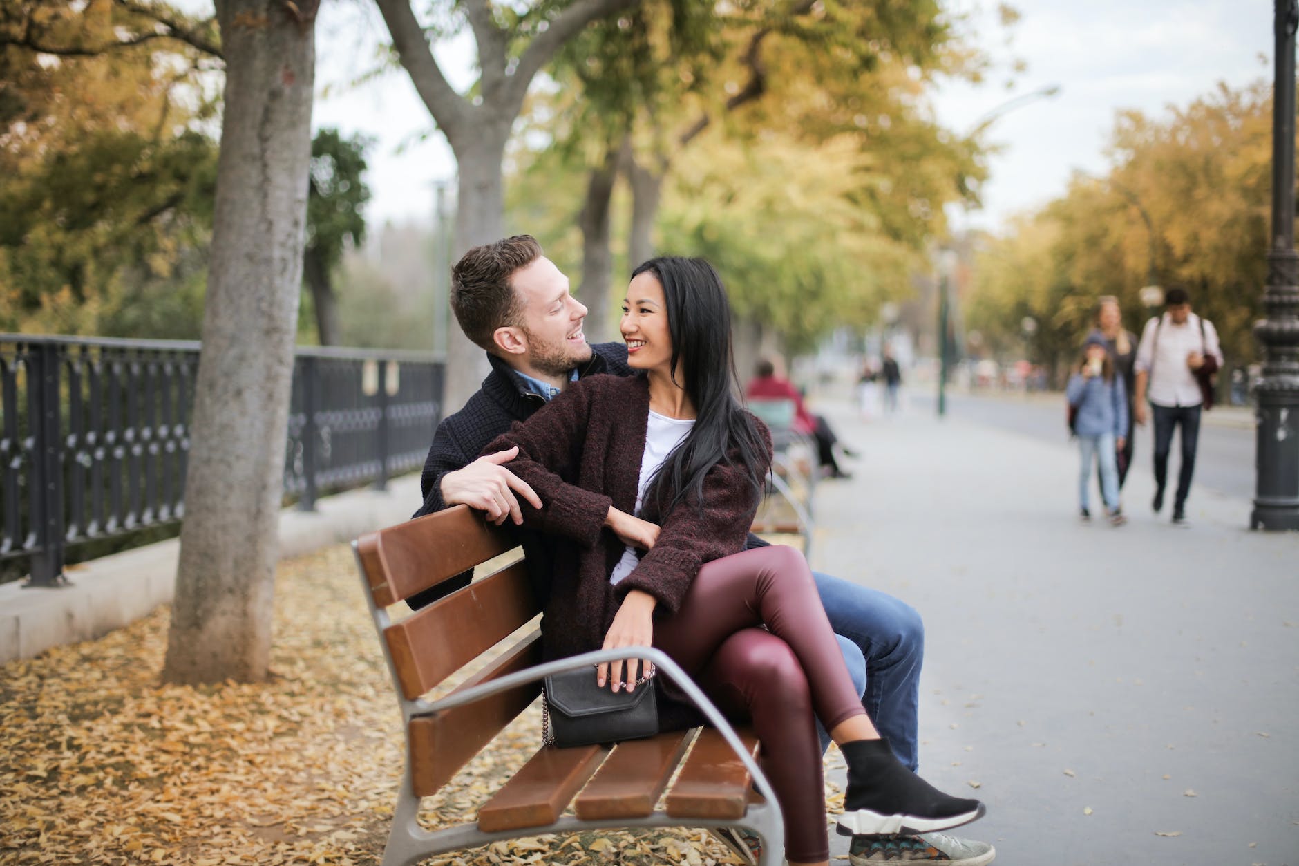 Interracial couple sitting on bench after matchmaking in Washington DC