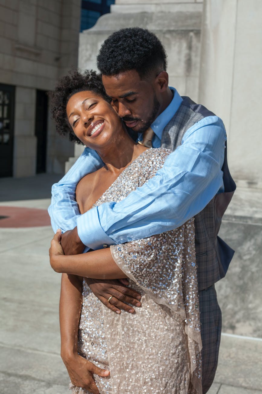 African American couple standing and embracing in the sun
