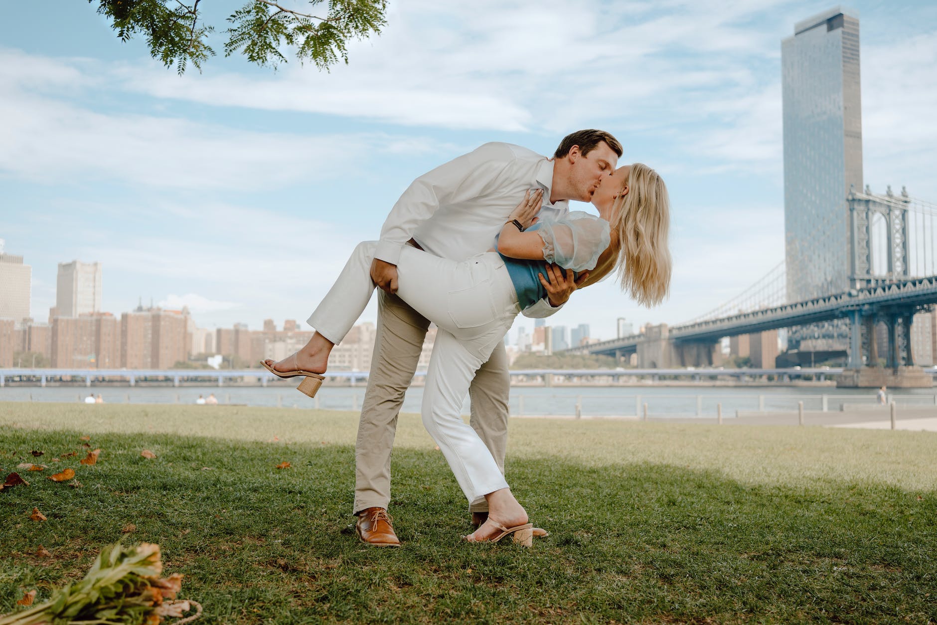 Caucasian couple kissing with city skyline in the background