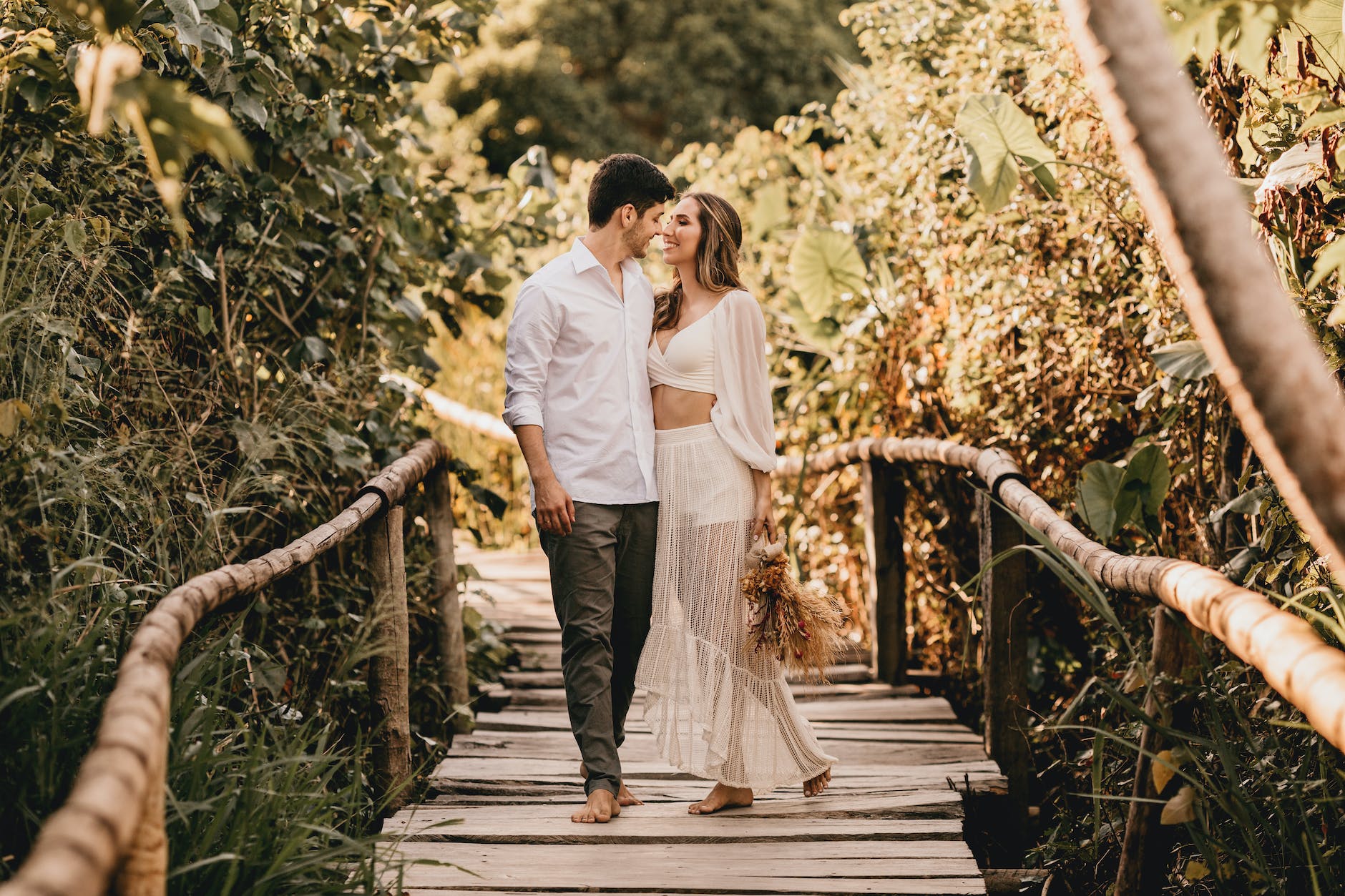 Caucasian couple smiling and standing on a bridge after meeting via a free dating site without payment