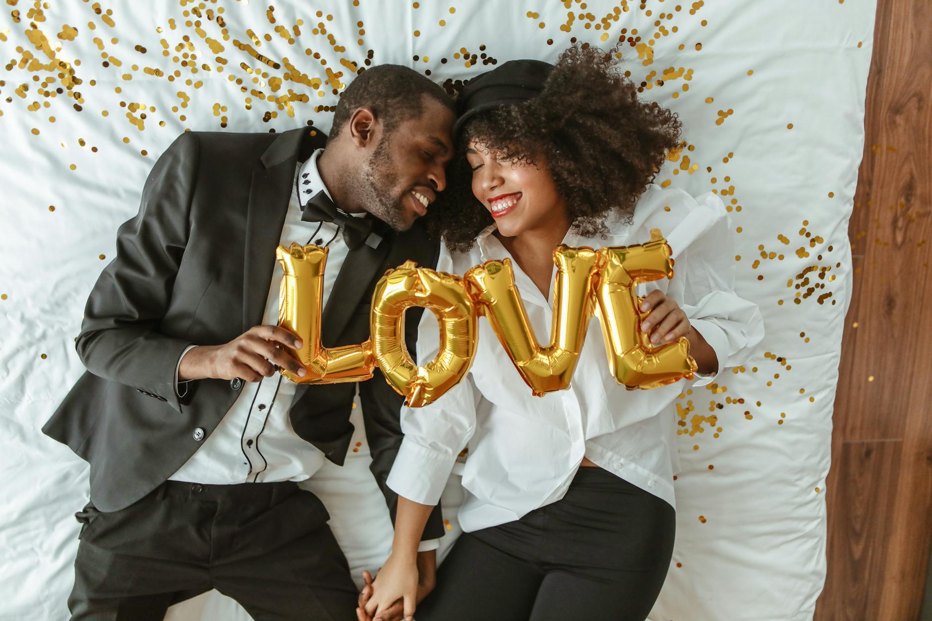 African American couple holding up a love sign after finding out how to heal from a broken heart