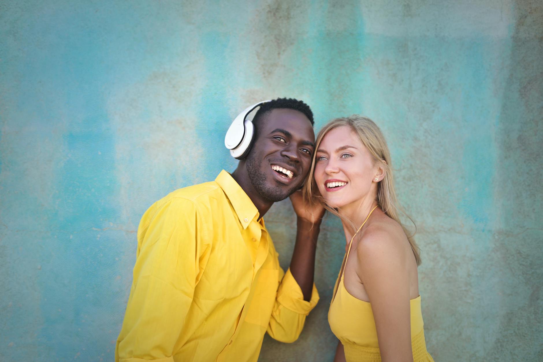 Interracial couple paired by matchmakers in New Orleans wearing yellow shirts and smiling