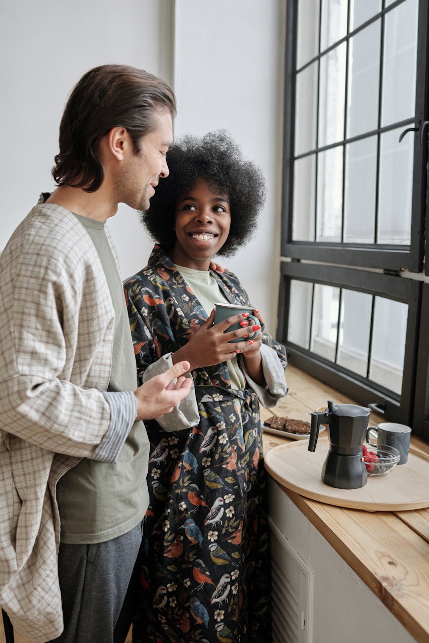 Interracial couple paired by matchmakers in Baton Rouge standing smiling at each other at breakfast