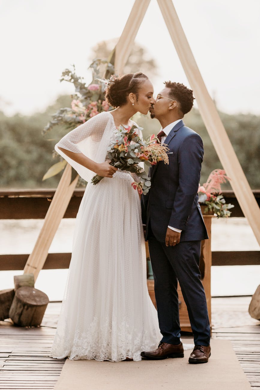 Black couple paired by matchmakers in Alexandria kissing on their wedding day
