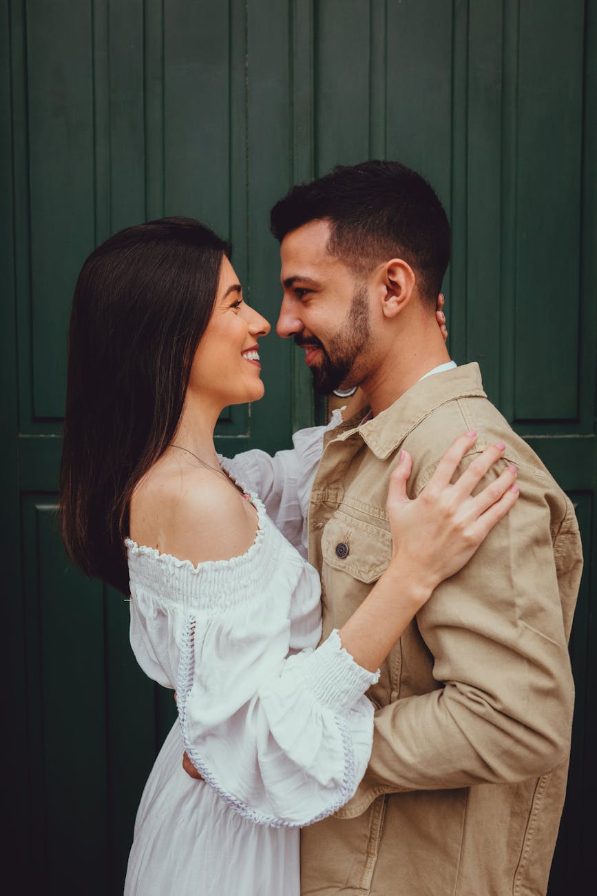 White couple matched by dating coaches for men smiling and hugging each other