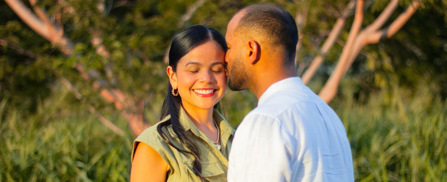 Asian couple paired by dating coaches for men kissing at sunset