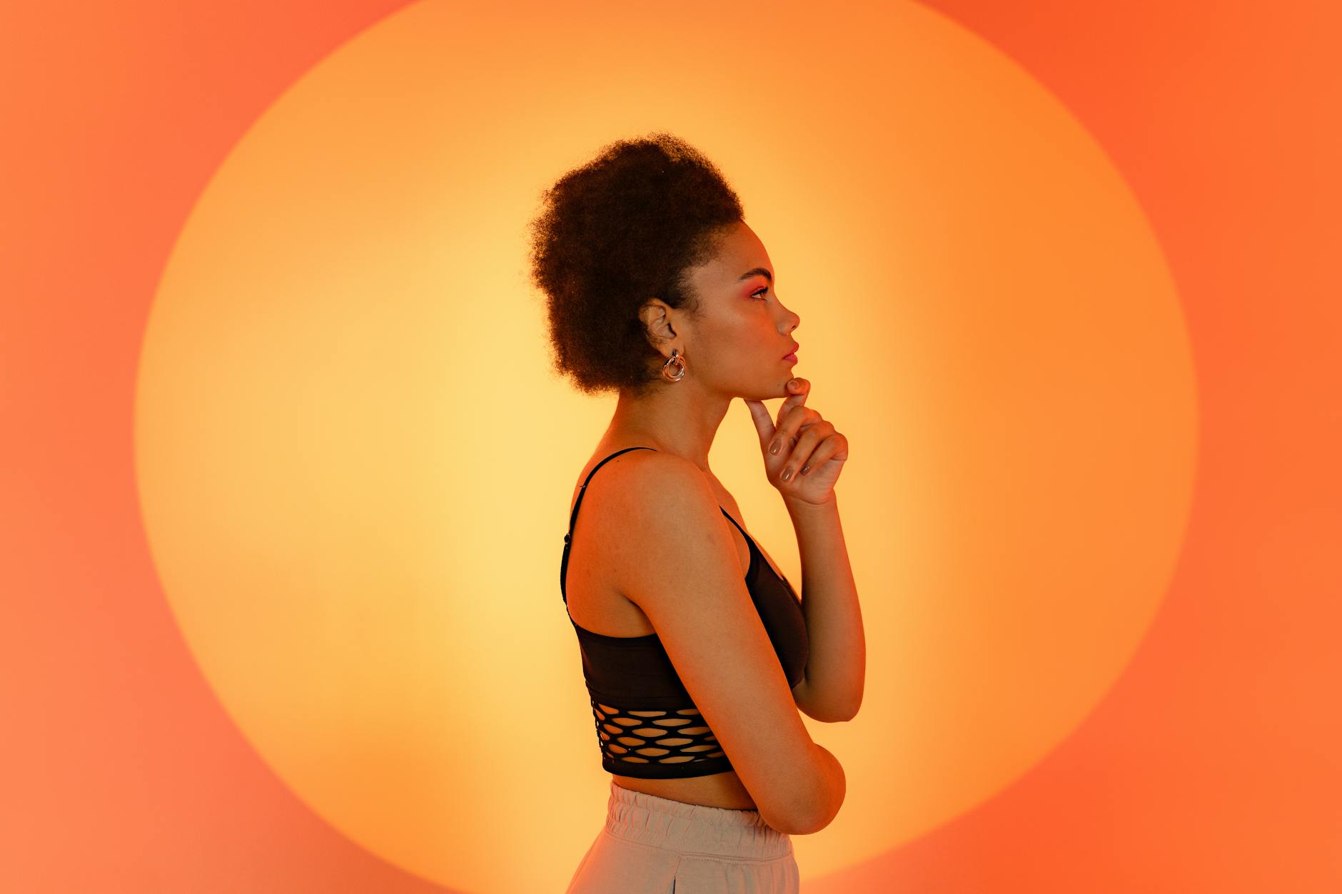 Black woman with natural hair thinking hard while standing to the side