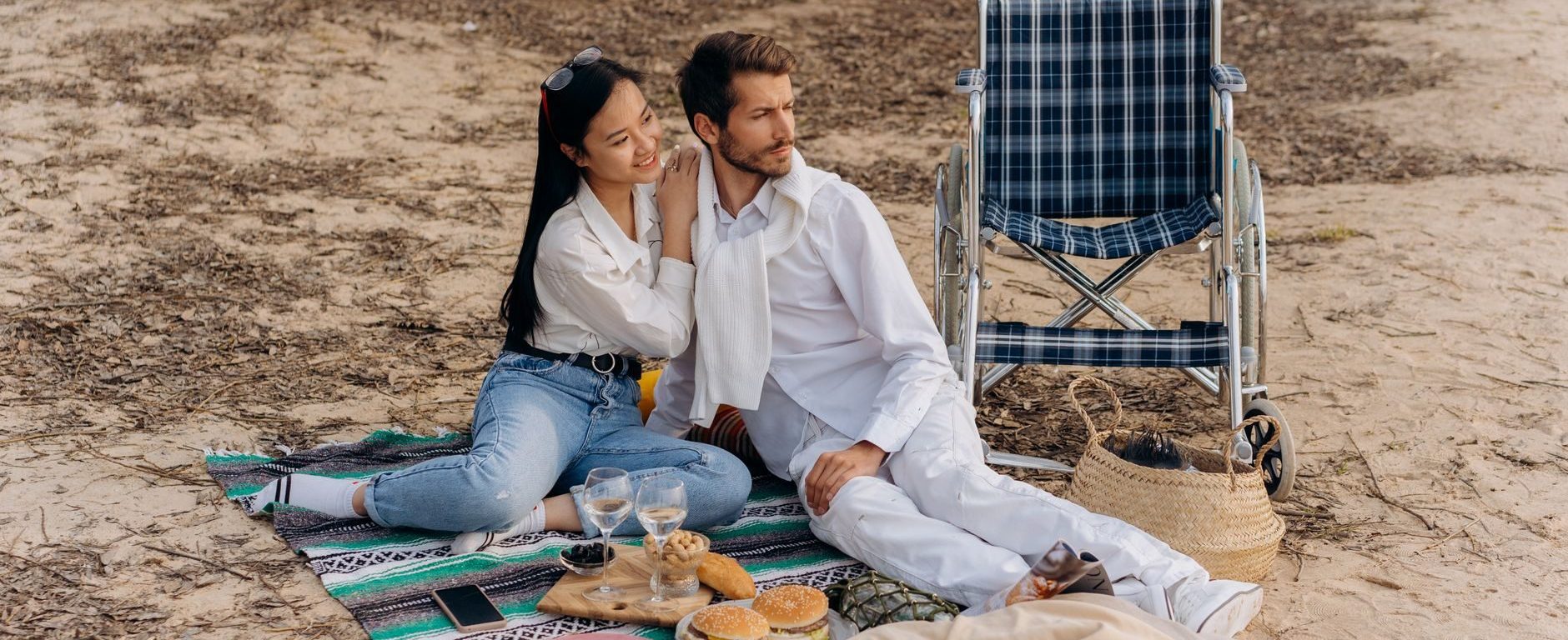 Interracial couple on a beach enjoying disabled dating
